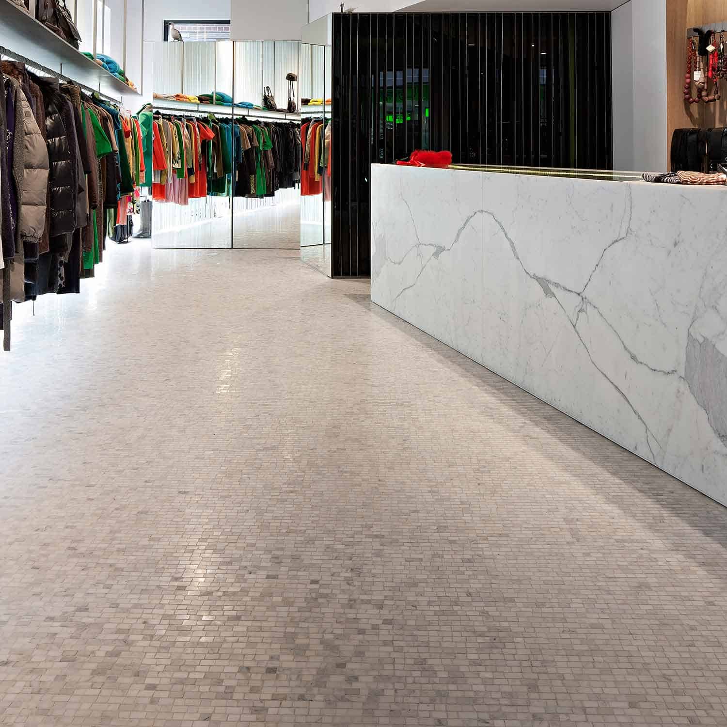 Book-matched Calacatta slabs and Carrara mosaics